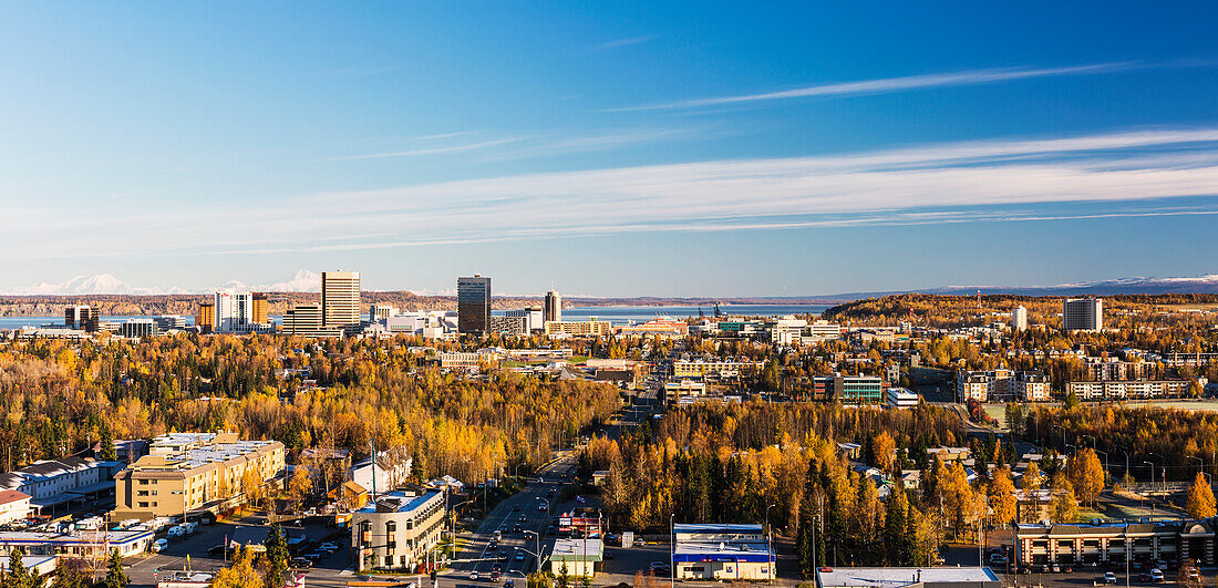 Aerial of downtown Anchorage during autumn with Mt. Foraker and Denali in the background, Southcentral Alaska, USA