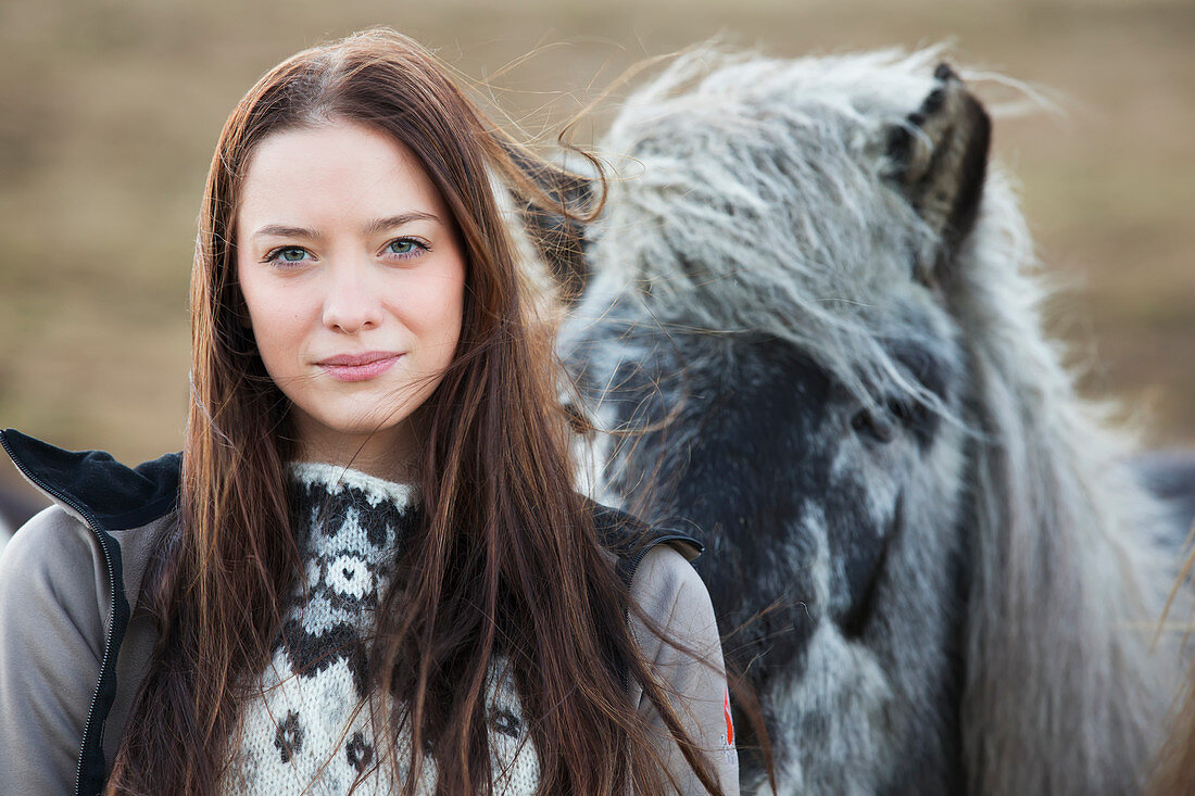 'Icelandic Woman Standing With An Icelandic Horse; Iceland'