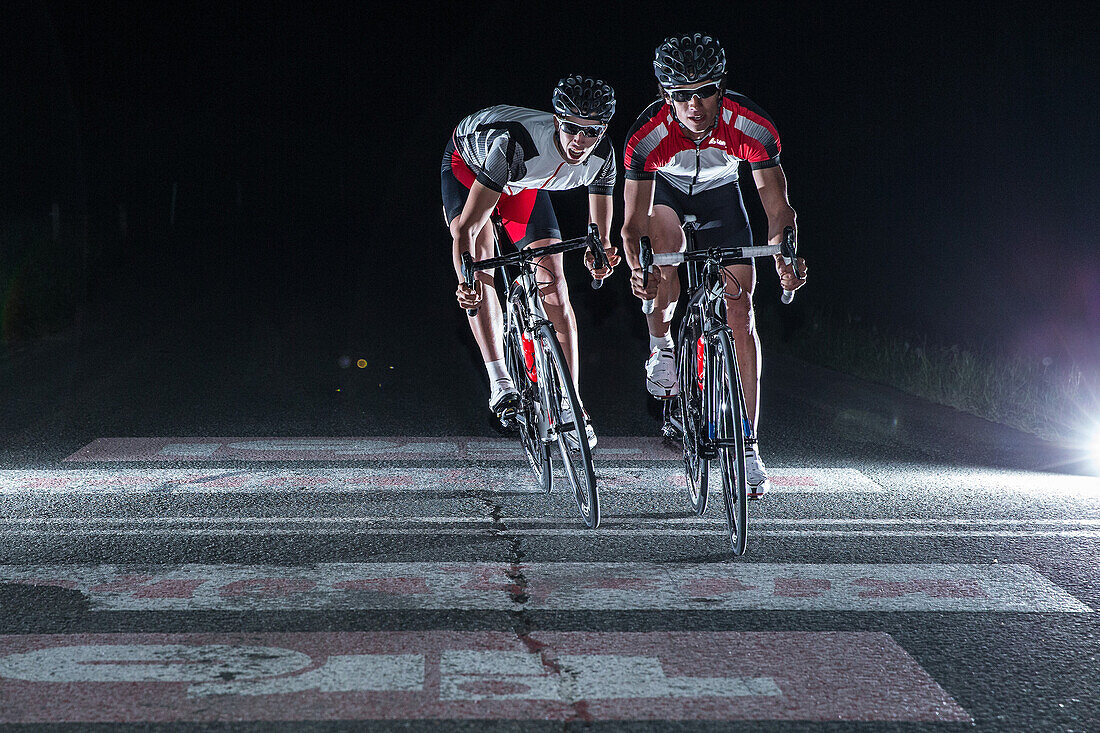 Young men having a race with their racing cycles in the Kitzbühler Alps, Kitzbühlerhorn, Tyrol, Austria