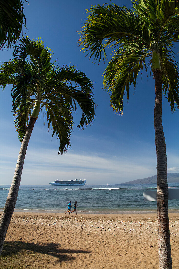 'Joggers on beach, cruise ship off of Puamana Beach just south of Lahaina town; Lahaina, Maui, Hawaii, United States of America'