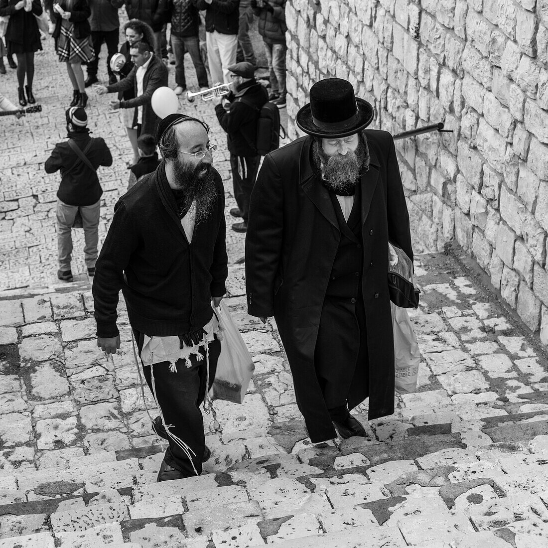 'Jewish men walking up steps talking together; Safed, Galilee, Israel'