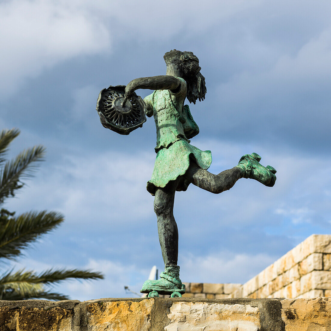 'Sculpture of a girl riding roller skates and playing with a toy; Ein Hod, Haifa District, Israel'