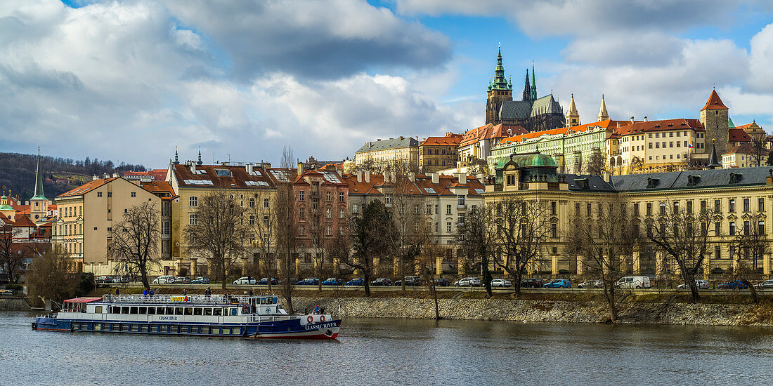 'A boat on the Vltava River with a view of the city of Prague; Prague, Czech Republic'