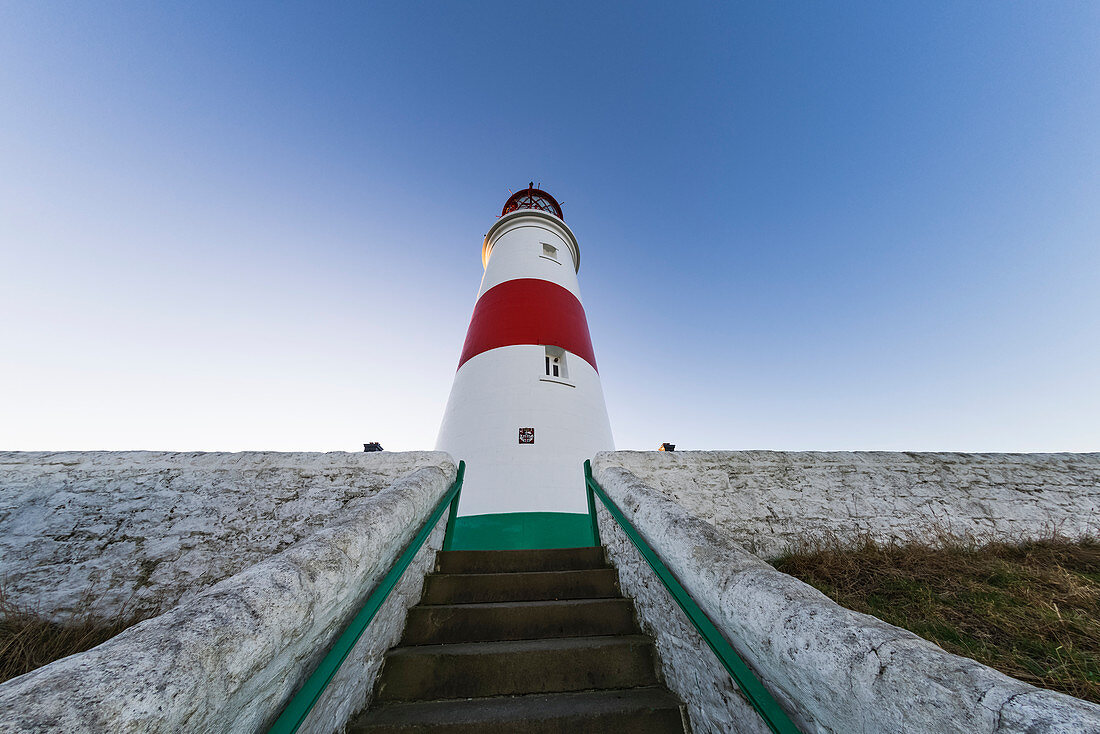 Low angle view of steps leading to a lighthouse against a blue sky, South Shields, Tyne and Wear, England