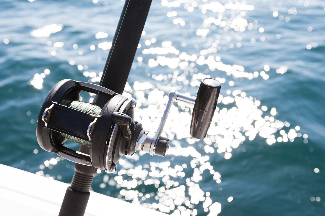 Close-up of the reel on a fishing rod and sparkling water from the sunlight, Homer, Alaska, United States of America