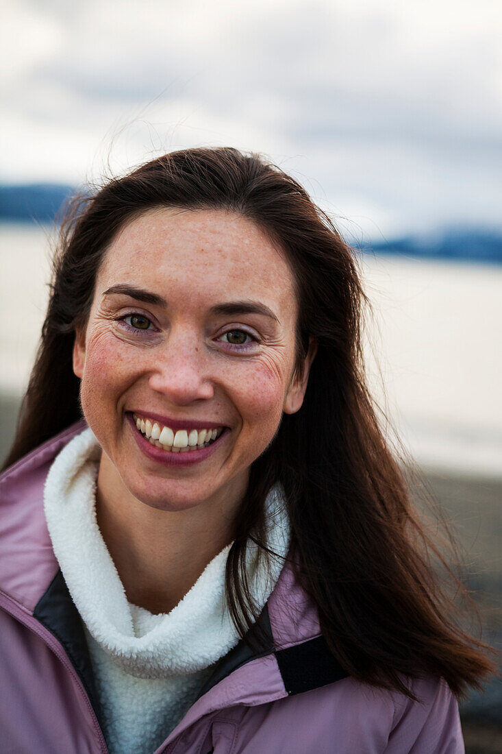 Portrait of a smiling woman with long brunette hair, Homer, Alaska, United States of America