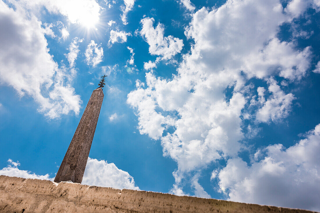 The obelisk Obelisco Sallustiano above the Spanish Steps against the light in front of very expressive sky, Rome, Latium, Italy