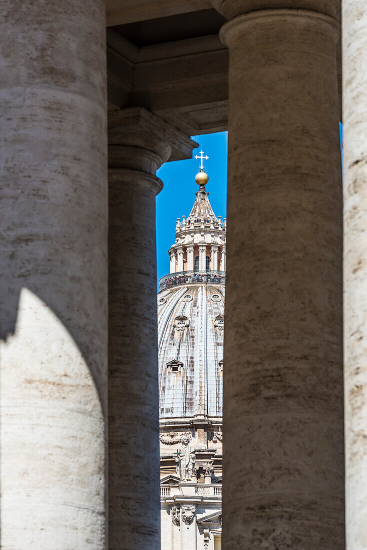 The dome of the St. Peter's Basilica Basilica di San Pietro seen from the columns at the St. Peter's square, Rome, Latium, Italy