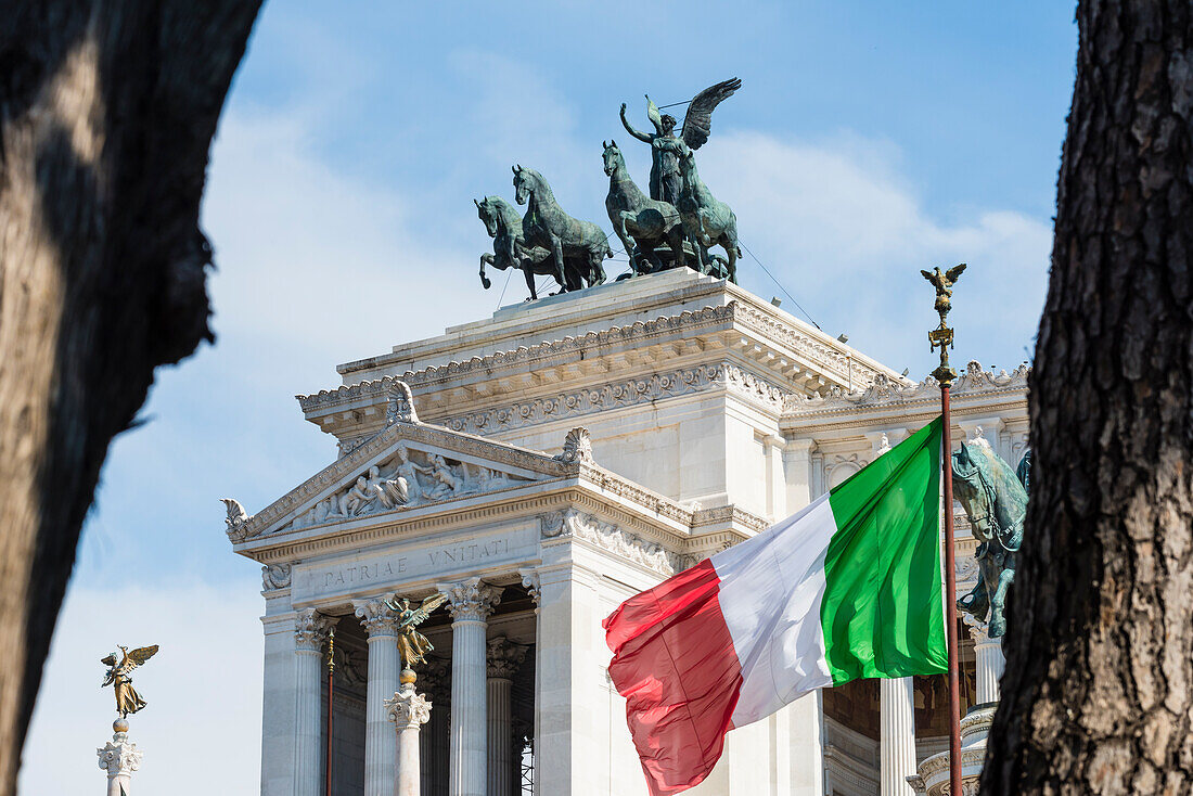 The monument Monumento a Vittorio Emanuele II with blowing national flag, Rome, Latium, Italy