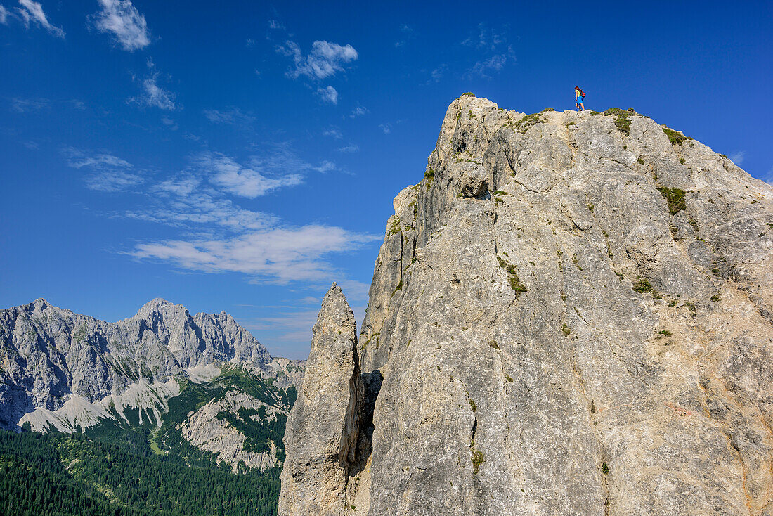 Woman hiking ascending towards Rappenklammspitze, Woerner in background, Rappenklammspitze, valley Rontal, Karwendel range, Natural Park Karwendel, Tyrol, Austria