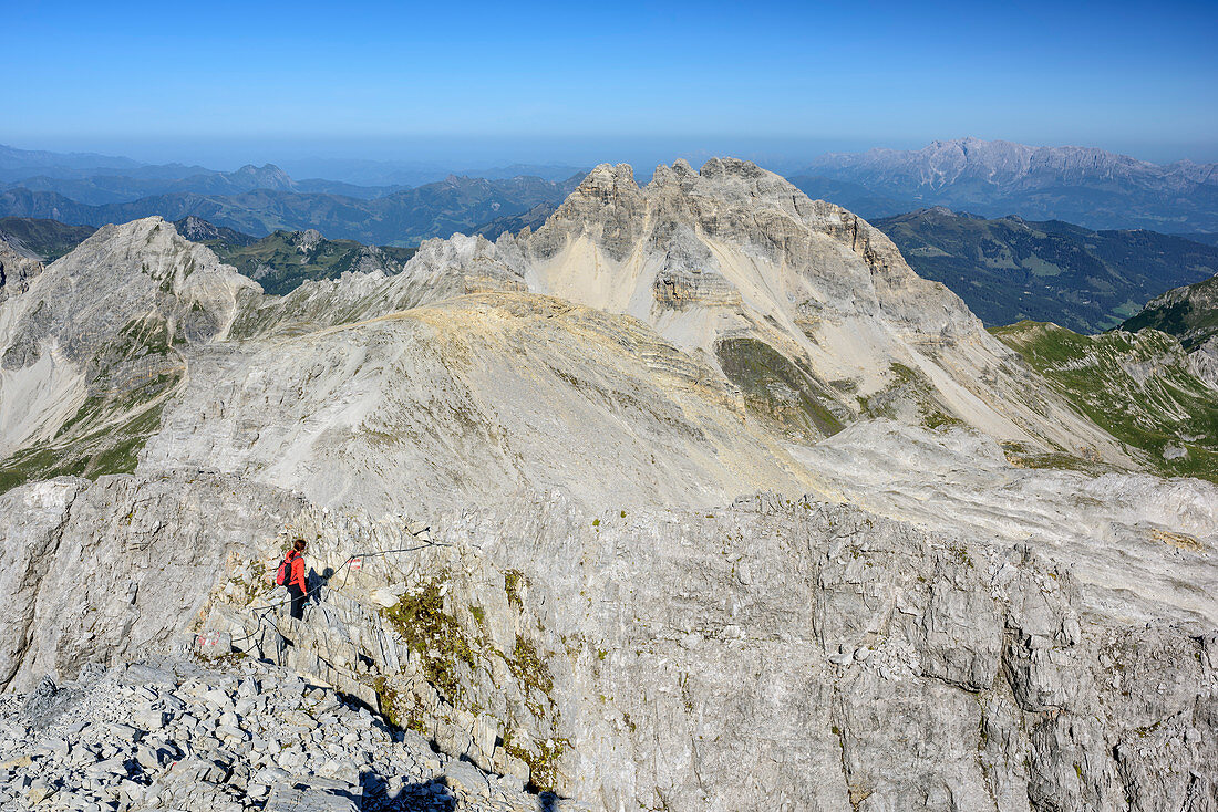 Woman hiking descending from Grosses Mosermandl, Faulkogel in background, Grosses Mosermandl, valley Riedingtal, Radstadt Tauern, Lower Tauern, Carinthia, Austria