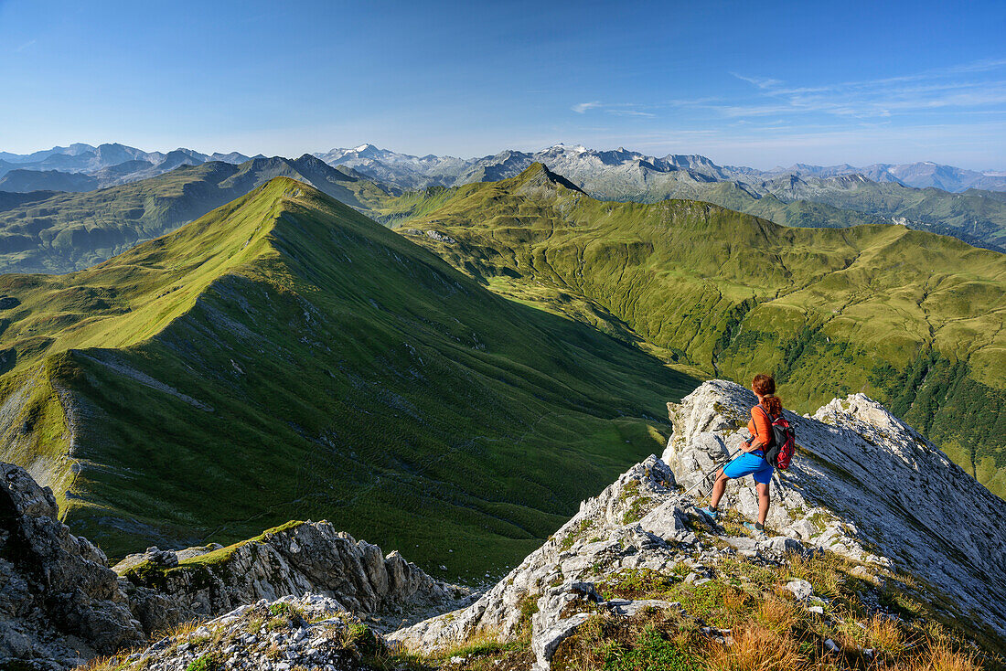 Woman hiking looking from Weissgrubenkopf towards Glingspitze, Weissgrubenkopf, valley Riedingtal, Radstadt Tauern, Lower Tauern, Carinthia, Austria