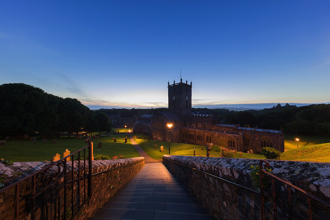 The historic St. David's Cathedral and Bishops Palace nestled in a natural valley at dusk in Pembrokeshire, Wales, United Kingdom, Europe