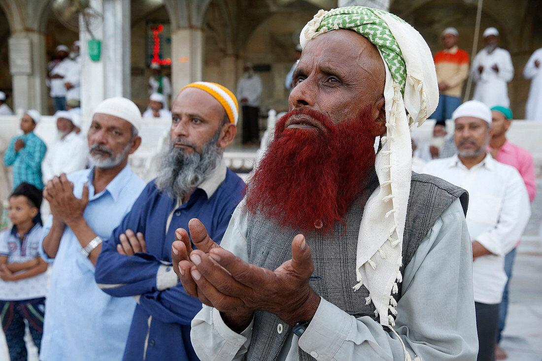 Muslim faithful turning towards the main shrine in the evening, Ajmer Sharif Dargah, Rajasthan, India, Asia