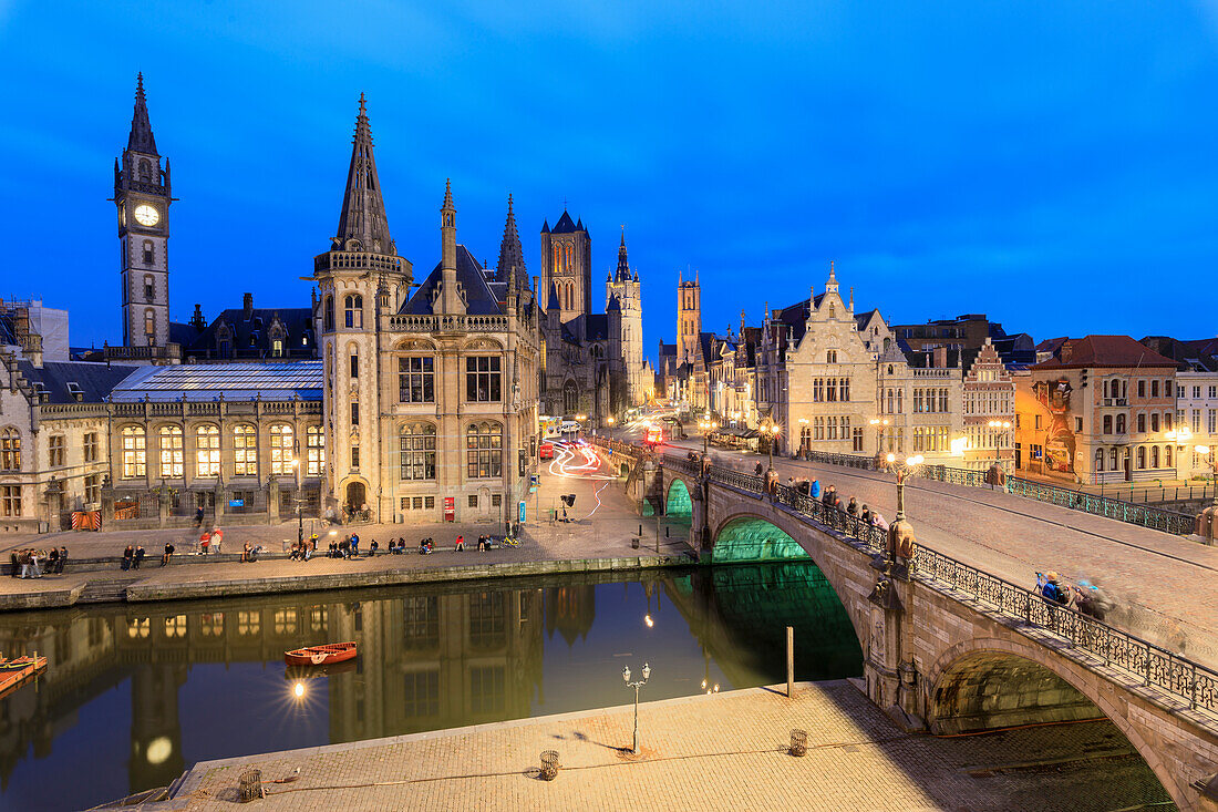 View of the historic area of Graslei and bell tower along Leie river at dusk, Ghent, Flemish Region, East Flanders, Belgium, Europe