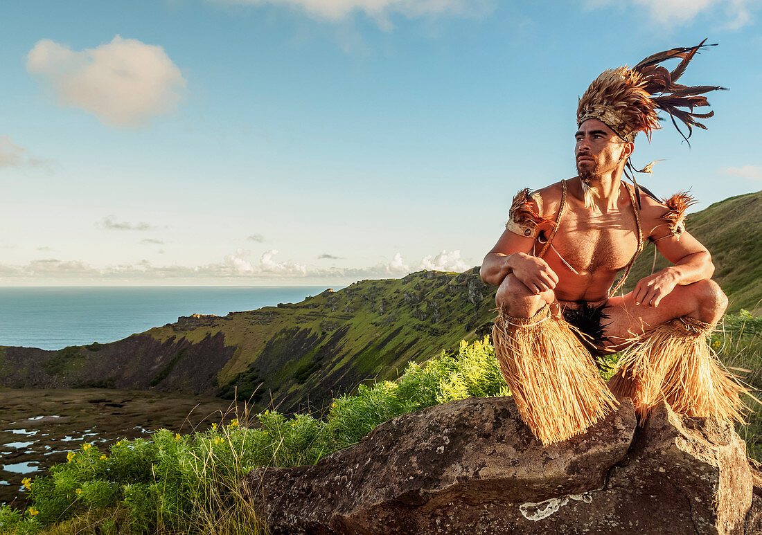 Native Rapa Nui man in tradititional costume on the rim of the Rano Kau Volcano, UNESCO World Heritage Site, Easter Island, Chile, South America