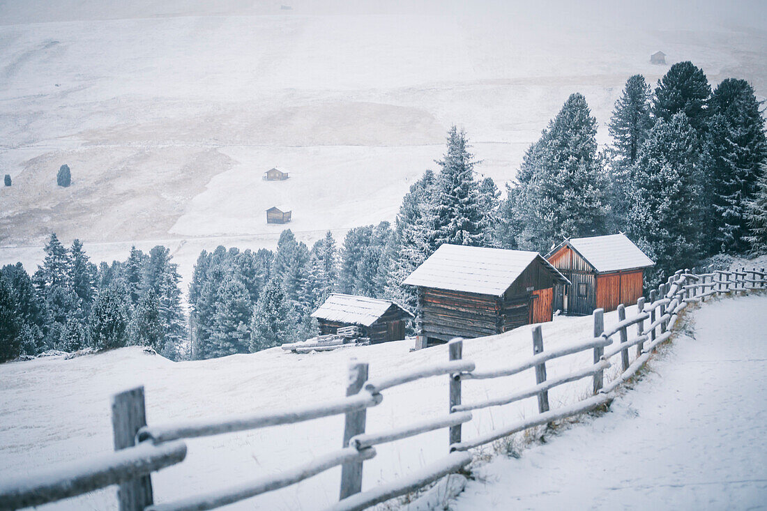 Some houses covered by snow into Puez Odle Natural Park, South Tyrol, Italy