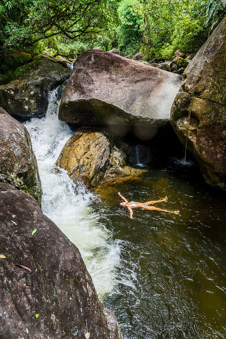 Woman bathing in Pirapetinga River in Serrinha do Alambari, Rio de Janeiro, Brazil