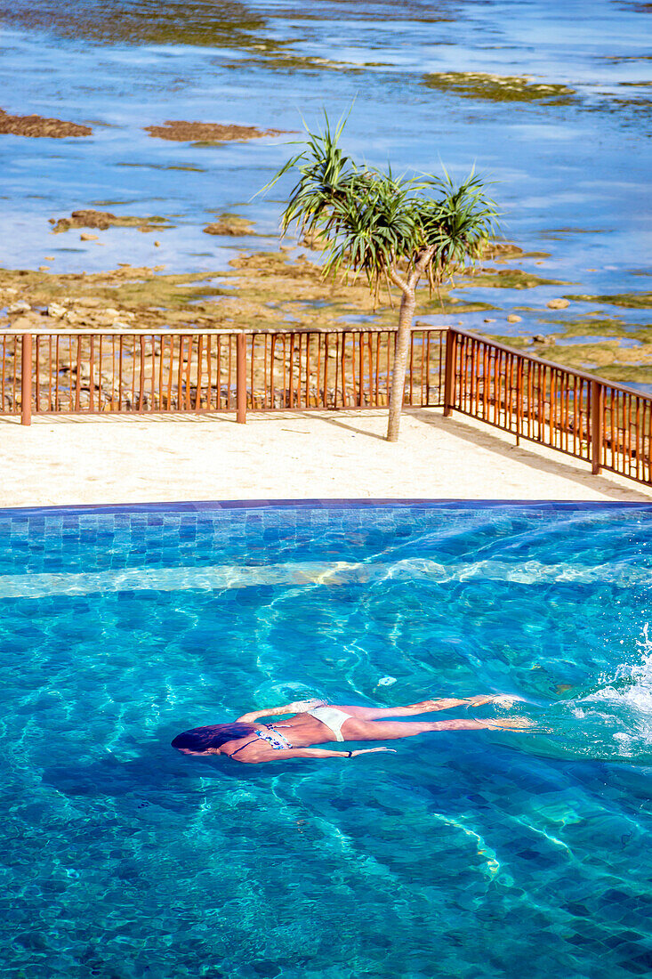 Young woman swimming in pool