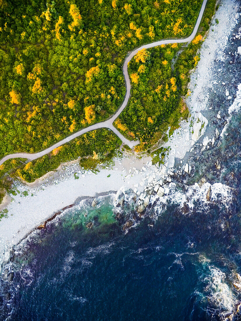 Aerial drone view of rocky shore and footpath in Rhode Island
