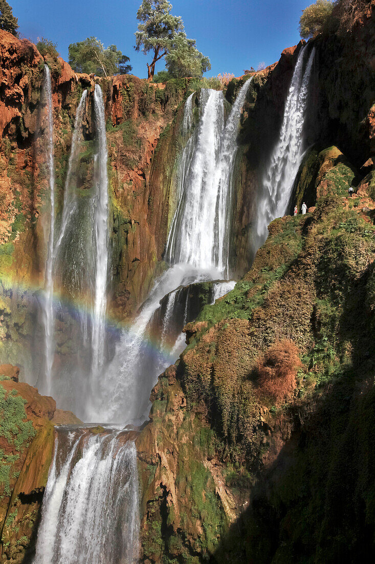 People are dwarfed by the waterfalls at Cascades D'Ouzoud in Morocco.