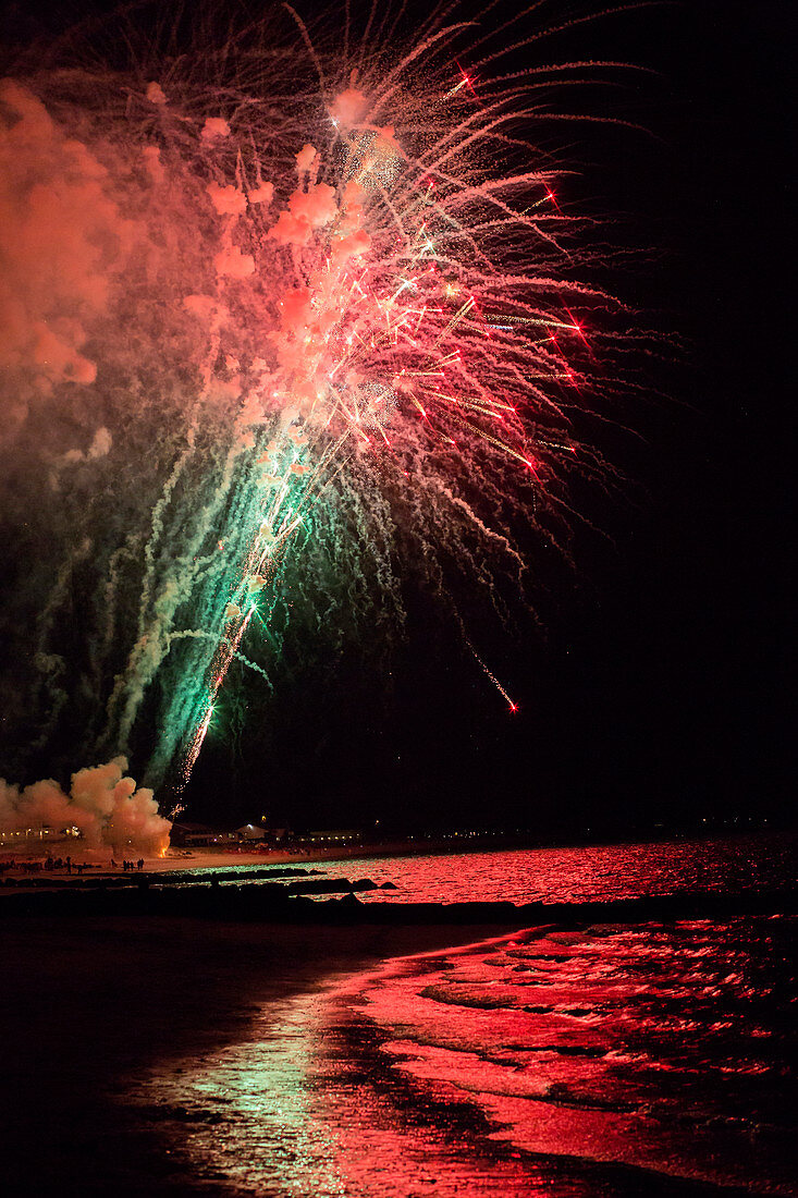 Fireworks explode over the ocean on Cape Cod, MA.