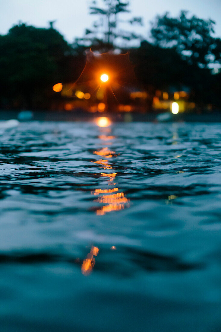 Illuminated coastal house at dusk