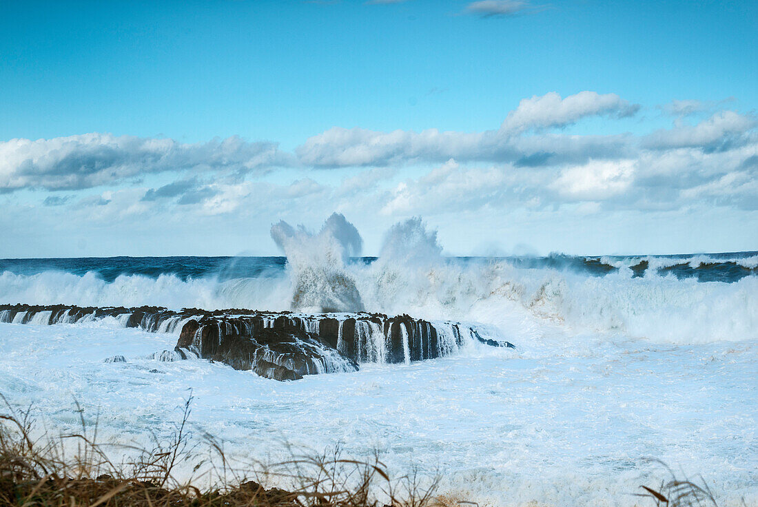 Huge whitewater waves crashing into rocks at Sharks Cove, north shore of Oahu, Hawaii, USA