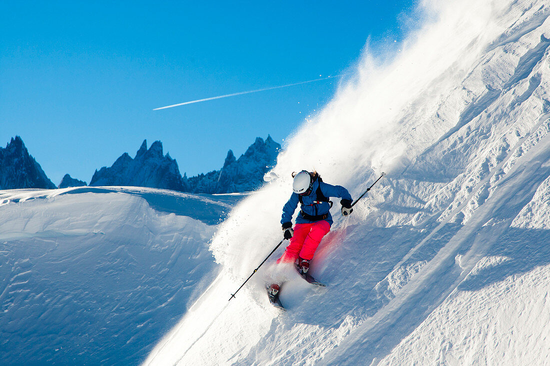 Andrea Binning skiiing through fresh powder down a steep mountainside. Chamonix, France