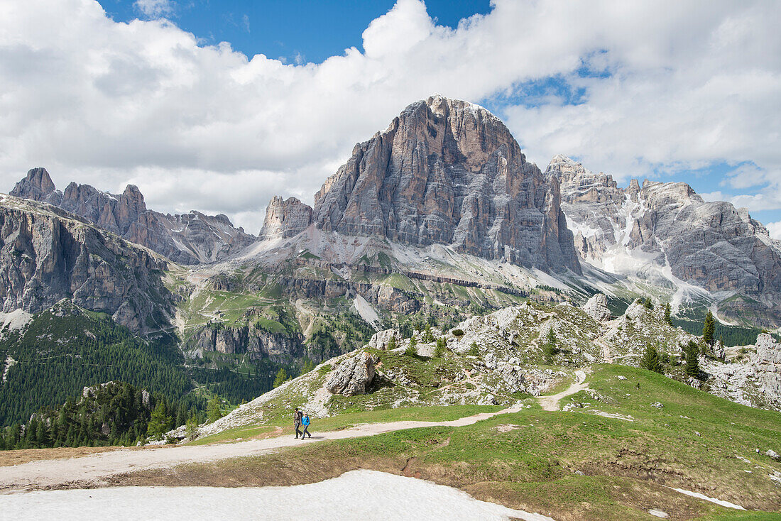 Long Exposure Of Couple Hiking At Cinque Torri Area In Dolomites, Italy