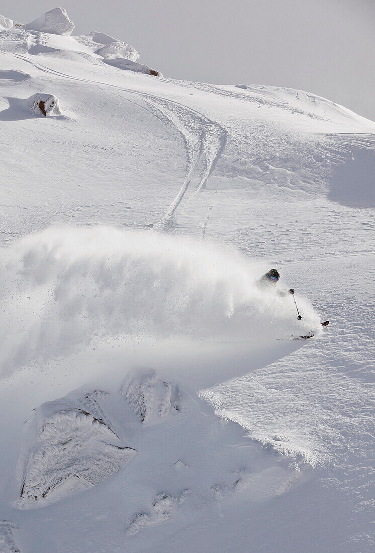 A Skier Makes A Turn And Sprays Powder Into The Air At Cerro Catedral, Argentina