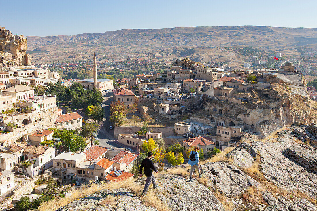 Two hikers over looking the old village of ??rg??p in Cappadocia, Turkey.