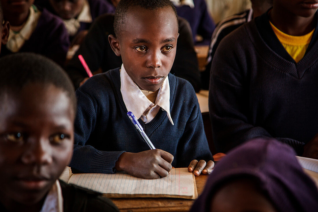 Solar Sister entrepreneur Julieth Mollelâ€™s grandson, Christian in school. Because of Juliethâ€™s work with Solar Sister Julieth is able to help pay the school fees for her four grandchildren. He attends a government primary school near Arusha, Tanzania.