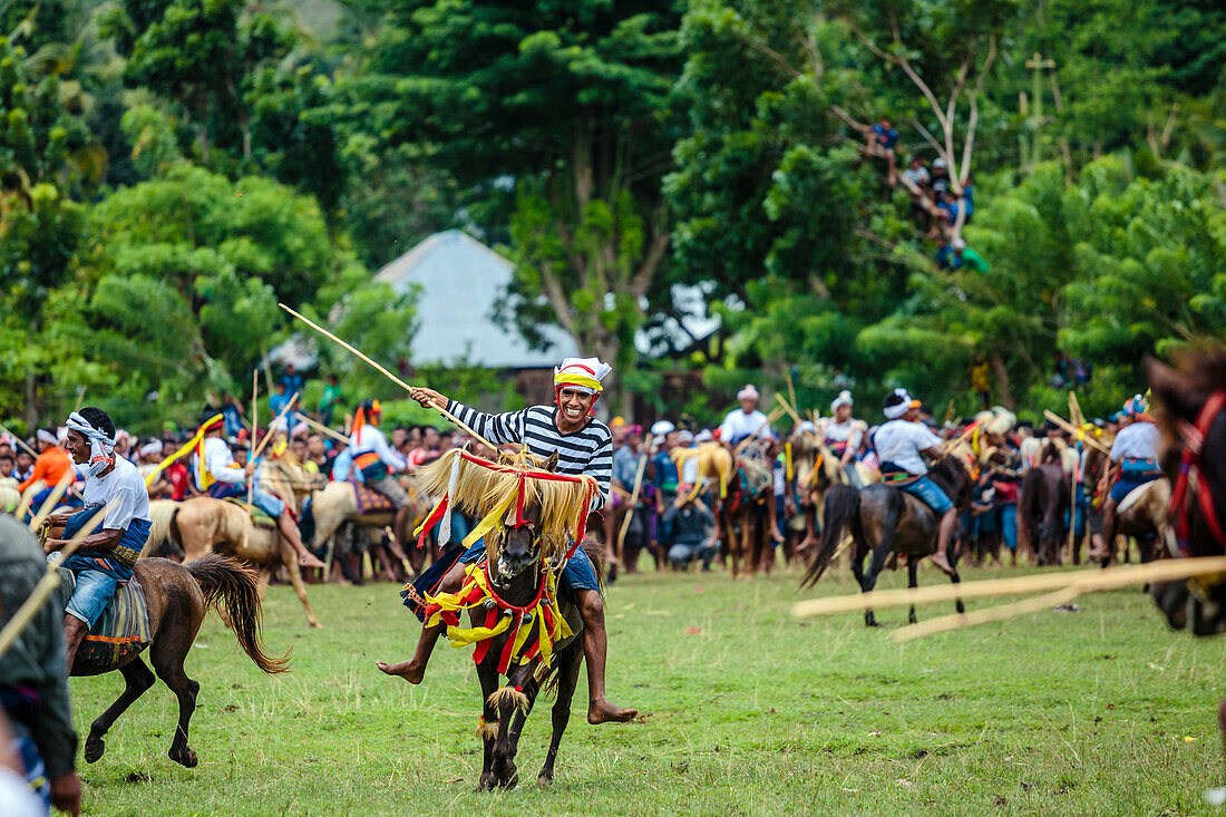 Männer Reiten Pferde und kämpfen mit Speeren in Pasola Festival, Insel Sumba, Indonesien