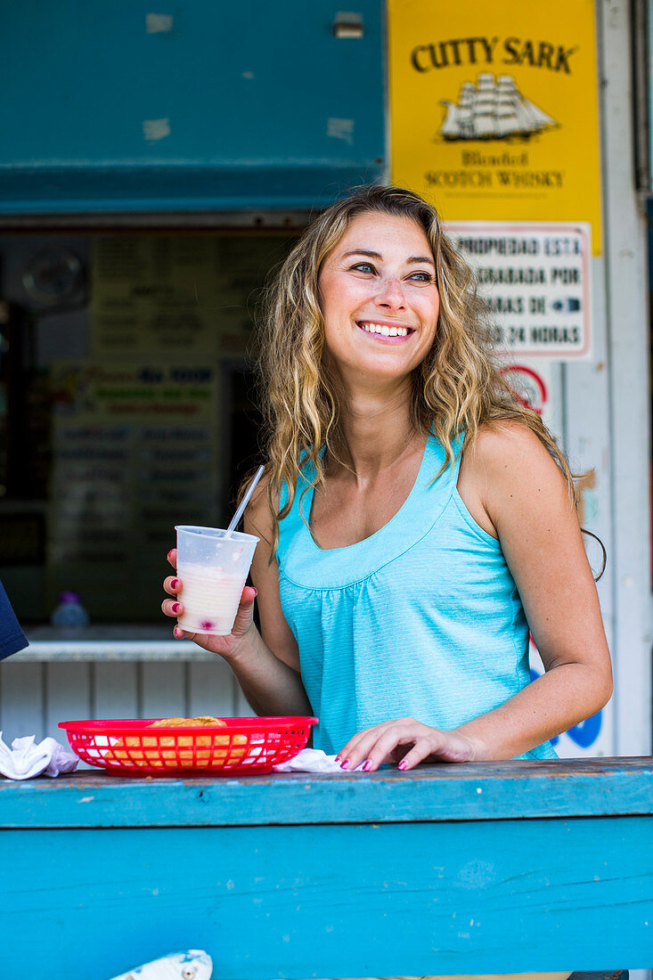 Smiling Young Woman At The Bar Of A Small Restaurant