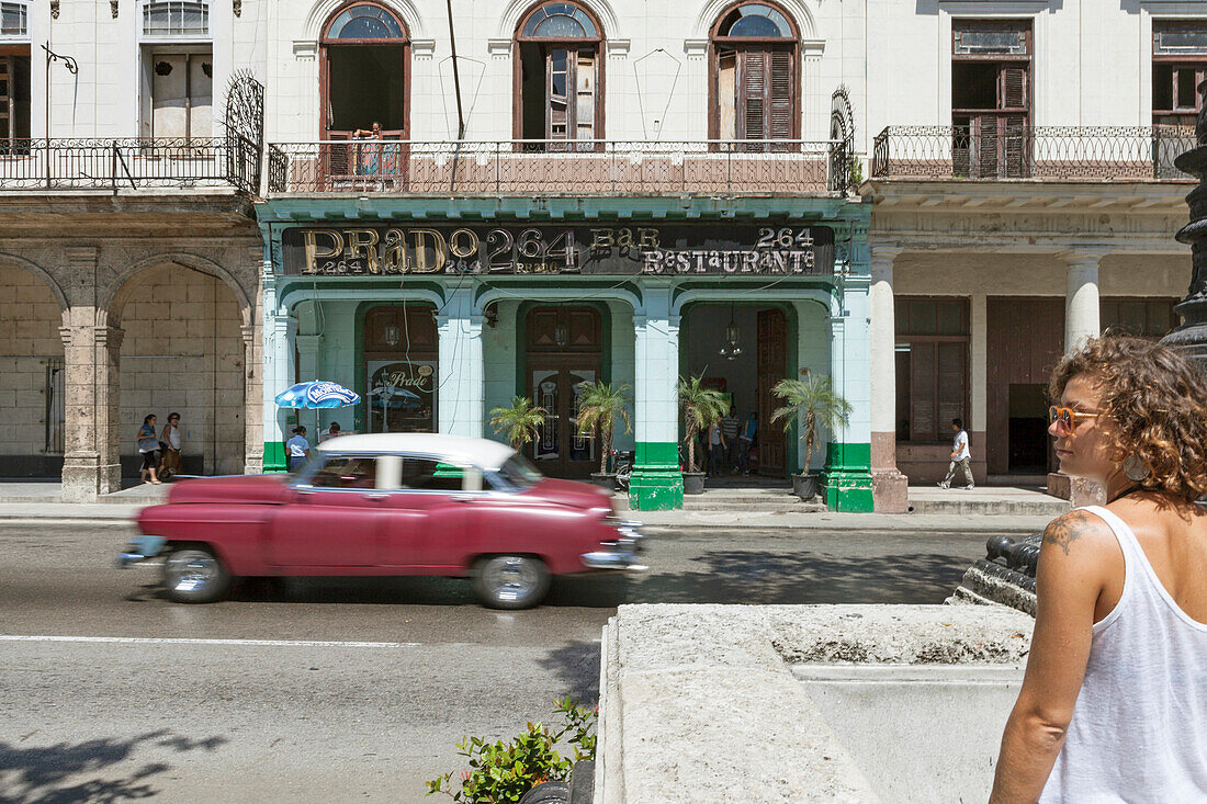 Tourist Girl In The Streets Of La Habana With An Old Car Moving In The Background