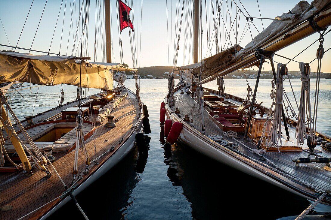 Moored vintage sailboats in the early morning. Port of Mahó, Minorca, Balearic Islands, Spain