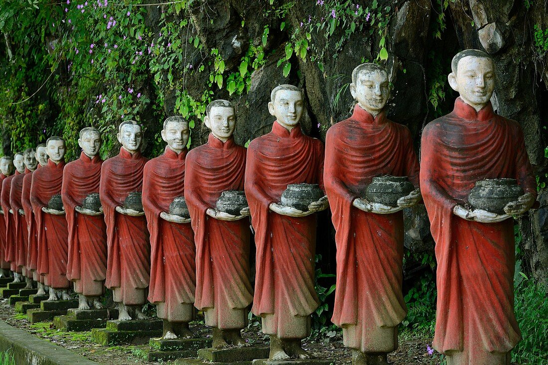 Myanmar, Kayin (Karen) State, Hpa-An surroundings, Monk statues with begging bowls near Kaw Ka Thawng cave.