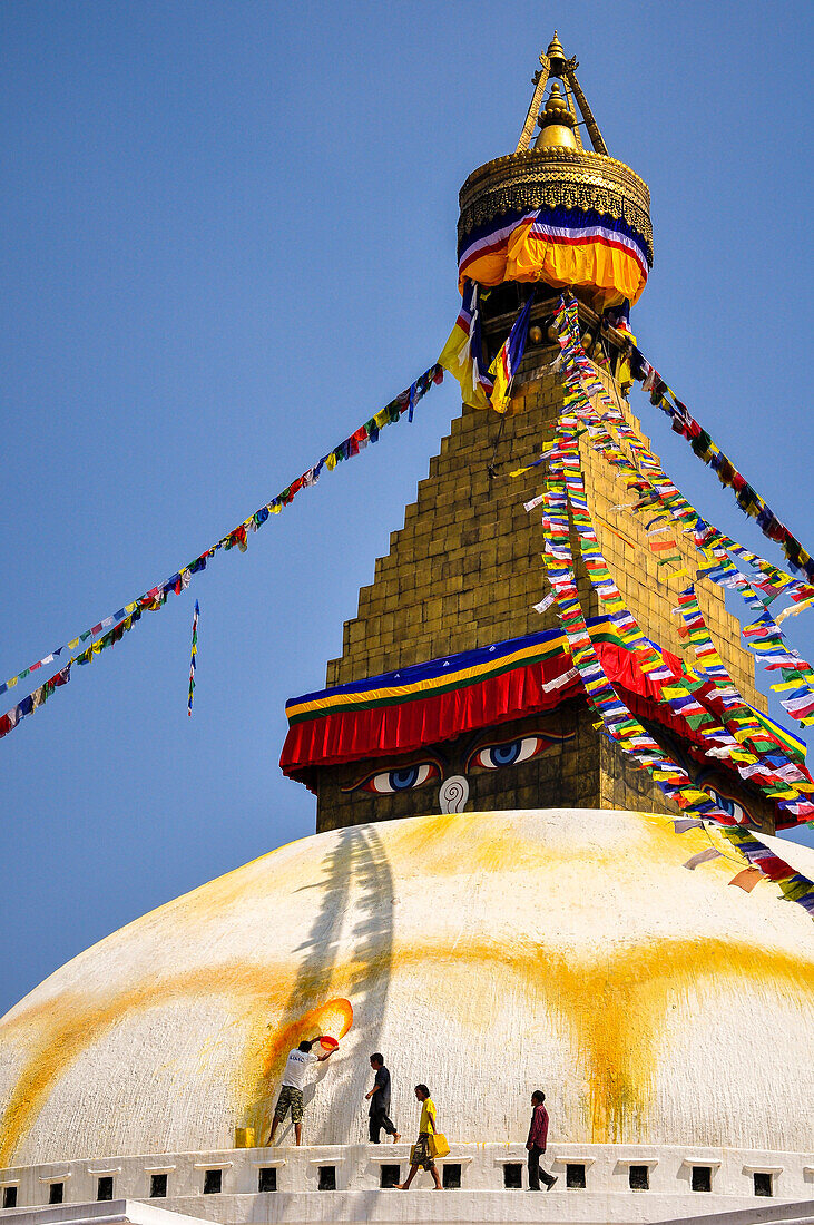 Bouddhanath Stupa with men refreshing yellow color,Kathmandu,Nepal,Asia