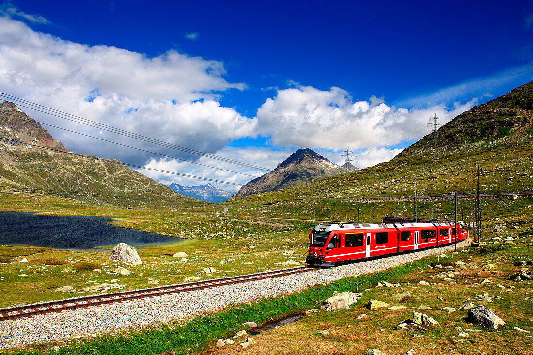 Bernina Pass with bernina express near at blak lake, Graubünden, Switzerland