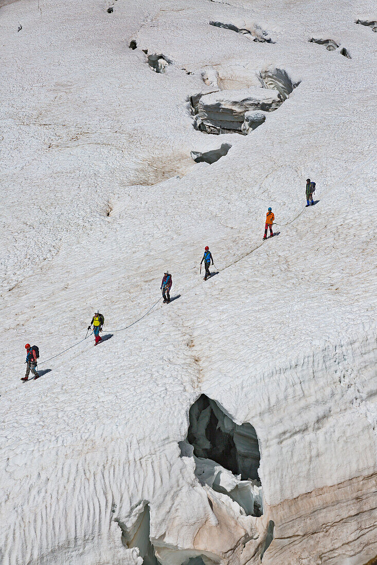 Mountaineers walk on Lys glacier near the Gnifetti refuge in Monte Rosa Massif (Gressoney, Lys Valley,  Aosta province, Aosta Valley, Italy, Europe)