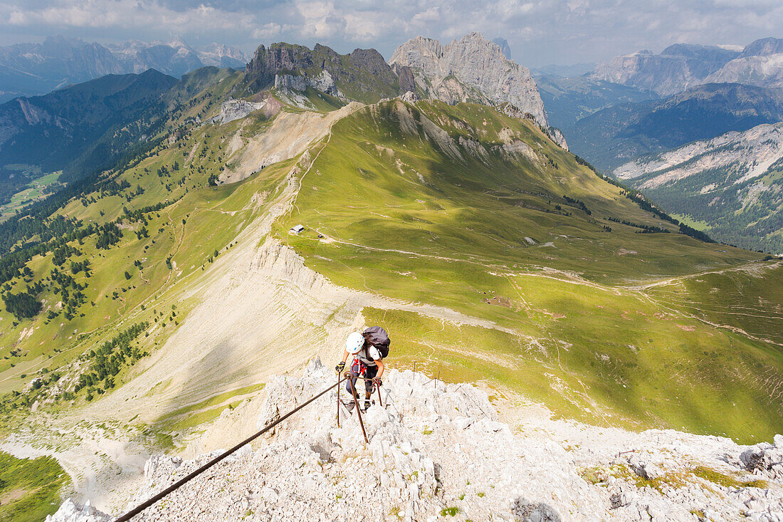 a hiker is climbing a very hard via ferrata, Trento province, Trentino Alto Adige, Italy