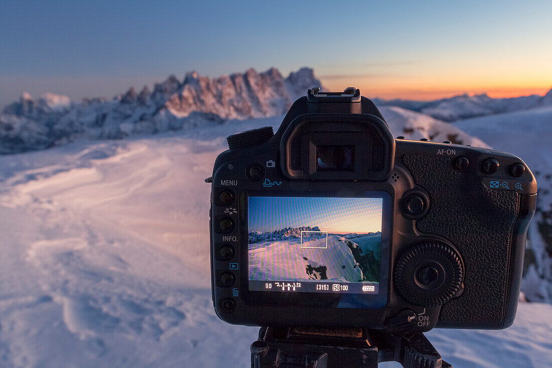 Europe, Italy, Veneto, Belluno, A SLR camera in mountain with live view display active frames the mountains in background