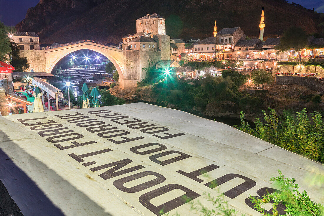 Old Bridge (Stari Most) and and a sentence Don't forget but do forgive, referring to the war in the Balkans, Mostar, Bosnia and Herzegovina