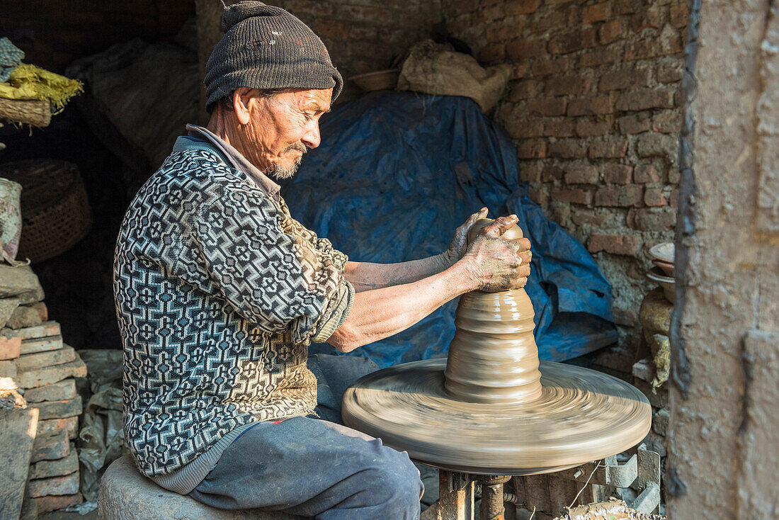 Bhaktapur, Kathmandu, Bagmati area, Nepal Old man works clay with lathe