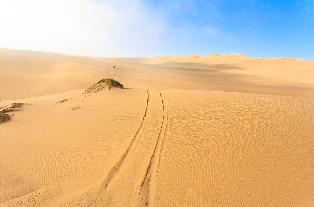 Traces of the Jeep on the sand dunes modeled by wind Walvis Bay Namib Desert Erongo Region Namibia Southern Africa