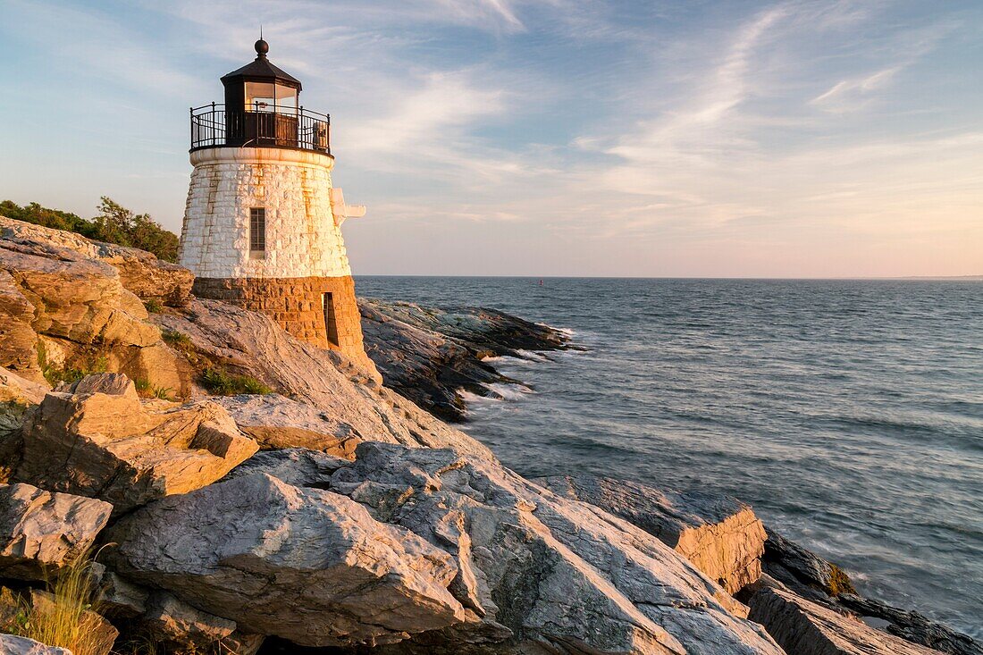 Castle Hill Lighthouse bathed in golden light in Newport, Rhode Island.