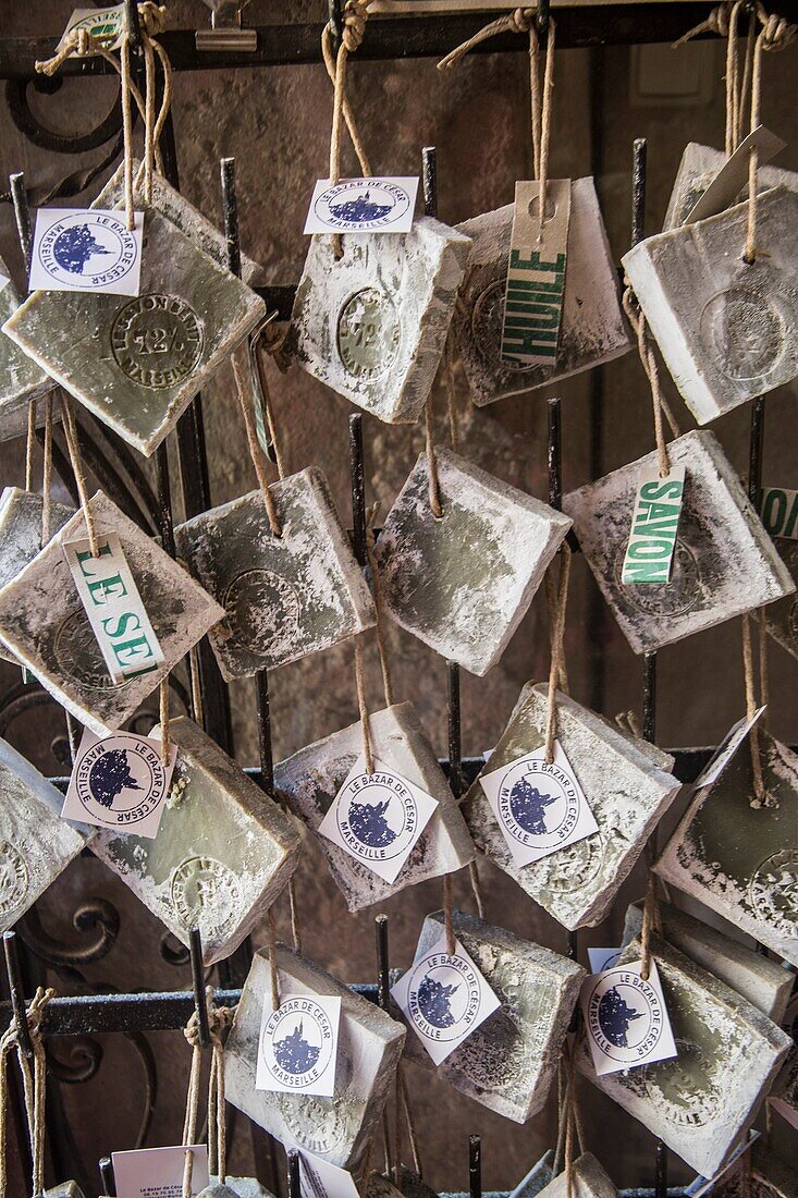 Typical soaps of Marseille hanging in window of store front, in the Quarter of Le Panier in Marseilles. Old streets in the neighboroud of Le Panier.