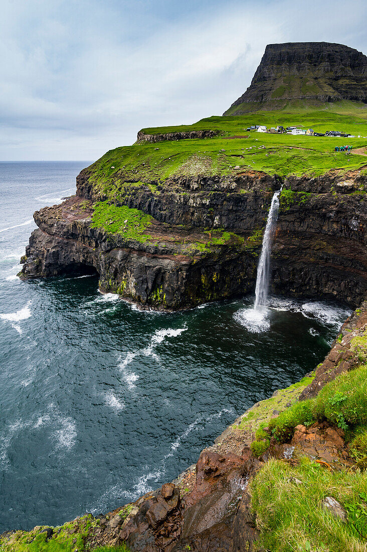 Gasadalur waterfall into the ocean, Vagar, Faroe Islands, Denmark, Europe