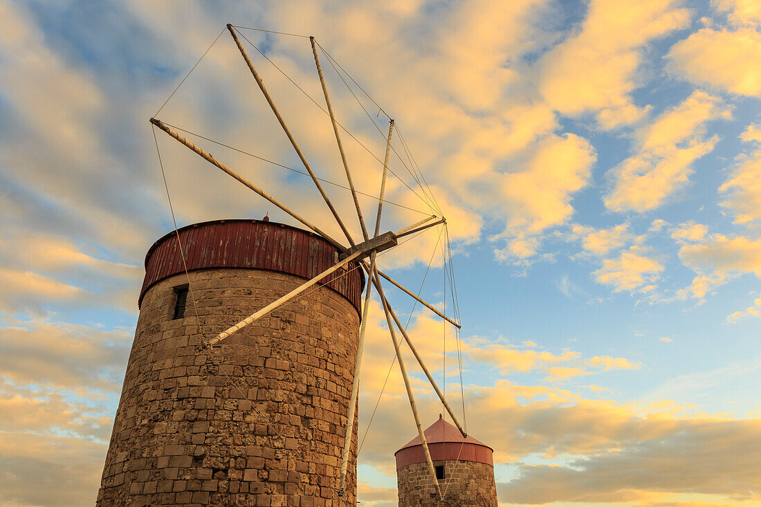 Mandraki Harbour medieval windmills at sunset, Rhodes, Dodecanese, Greek Islands, Greece, Europe